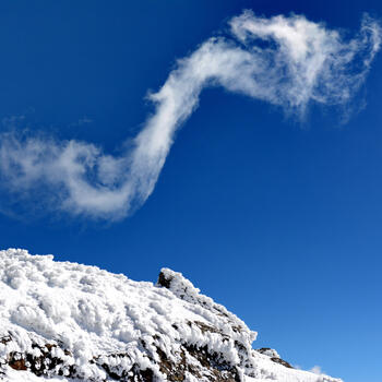 A lovely cloud swirls over the summit of Yunnan's Jiaozi Snow Mountain