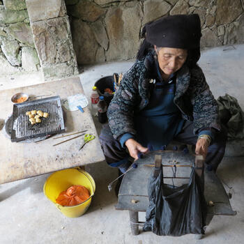 A Hani woman painstaking weaves embroidery flourishes for a new jacket in Yuanyang, Yunnan (image credit: Chiara Ferraris)