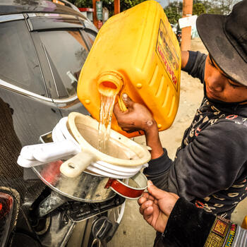 Buying roadside gas on the way to Putao, Myanmar