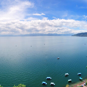 Paddle boats crowd the shore along Fuxian Lake