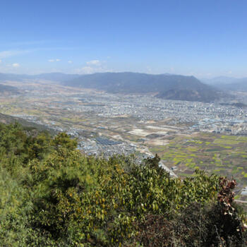 View from summit of Saddle Mountain. Left to right: Lashi Lake, north summit, Wenhai Mountain above north summit, Jade Dragon Snow Mountain, city of Lijiang, Wenbi Reservoir