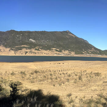 Wenhai Mountain rising above Wenhai Lake, Wenhai Village (right), Jade Dragon Snow Mountain (far right)